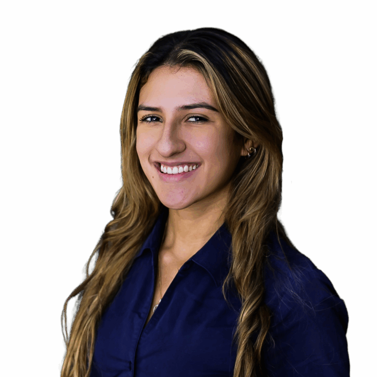 Angela Noguera, Centre Director from Busy Bees at Crace has long Bronde coloured hair and is wearing a navy coloured shirt. She is a smiling broadly into the camera.