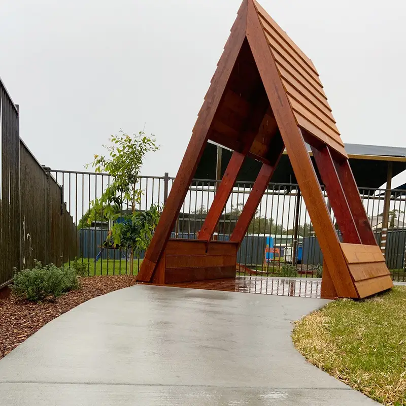 Wooden teepee in outdoor playground at Salt Ash preschool