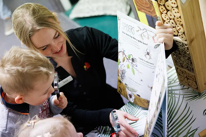 Busy Bees Early Childhood Educator reading book to children
