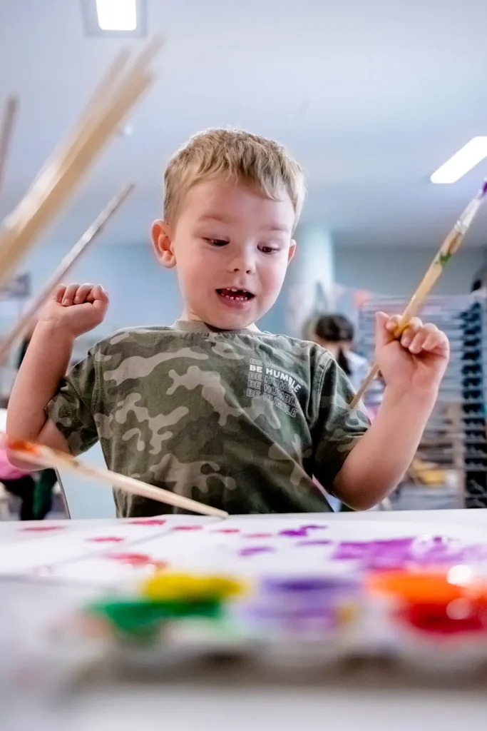 Kindergarten child painting at Springfield Lakes early learning