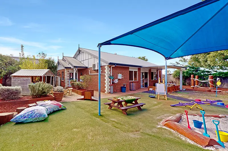 Outdoor playground with sandpit and cubby house at Warwick kindergarten