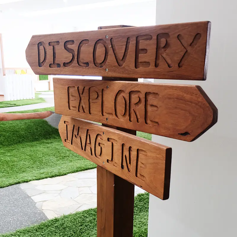 Wooden sign with the words: discovery, explore, and imagine
