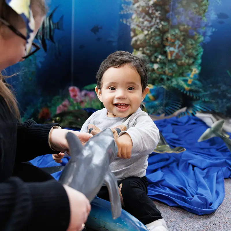 Baby playing with toy sea creatures