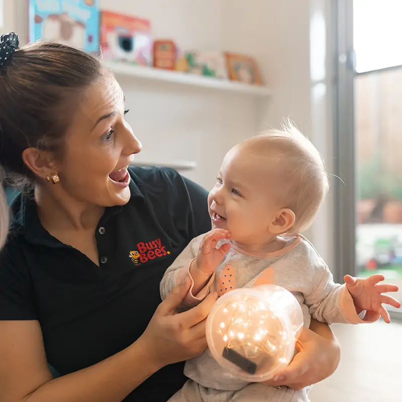 Busy Bees early childhood educator with baby