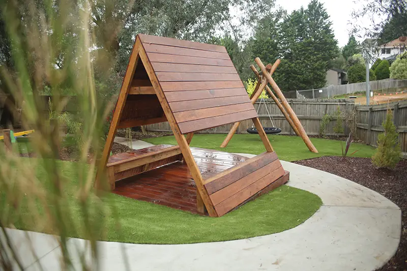 Timber triangle cubby house with winding bike path at Busy Bees Doncaster East