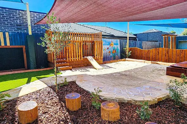 Sandpit and slide in toddler playground at Busy Bees at Glenroy