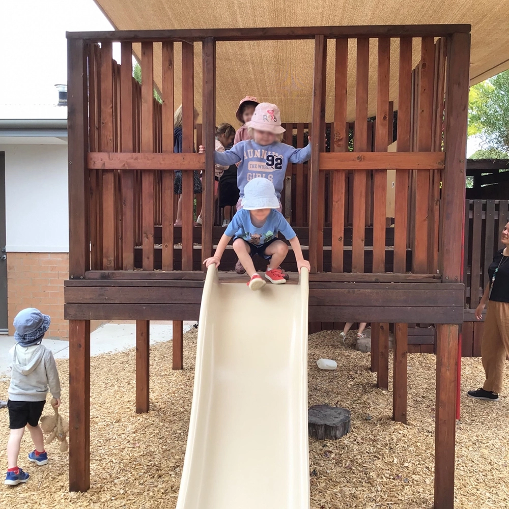 Wooden fort with slide at Busy Bees Early Learning located at Lara