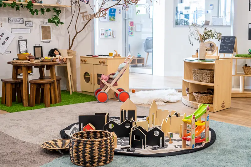 childcare room with blocks and play kitchen