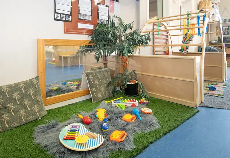 Busy Bees nursery room with soft play area for babies with musical instruments