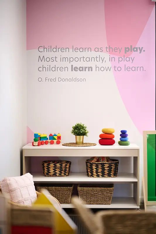 Quote on wall at Busy Bees Amberton Beach that says: "Children learn as they play. Most importantly, in play children learn how to learn. O. Fred Donaldson"