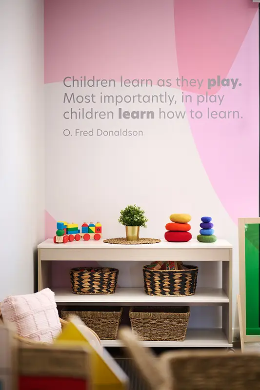Quote on wall at Busy Bees at Amberton Beach that says: "Children learn as they play. Most importantly, in play children learn how to learn. O. Fred Donaldson"