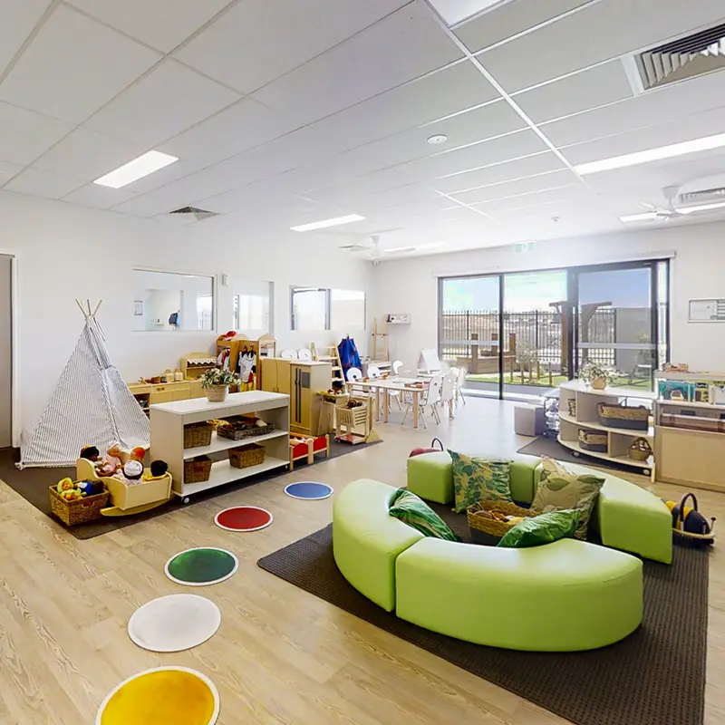 preschool room with reading area and fabric tent at Busy Bees at Amberton Beach