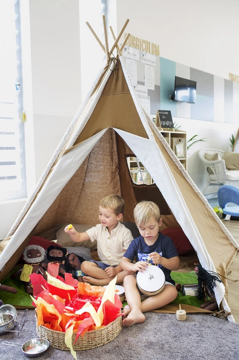Preschool children playing in tent
