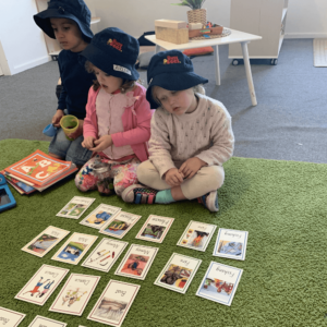 Children playing with name cards