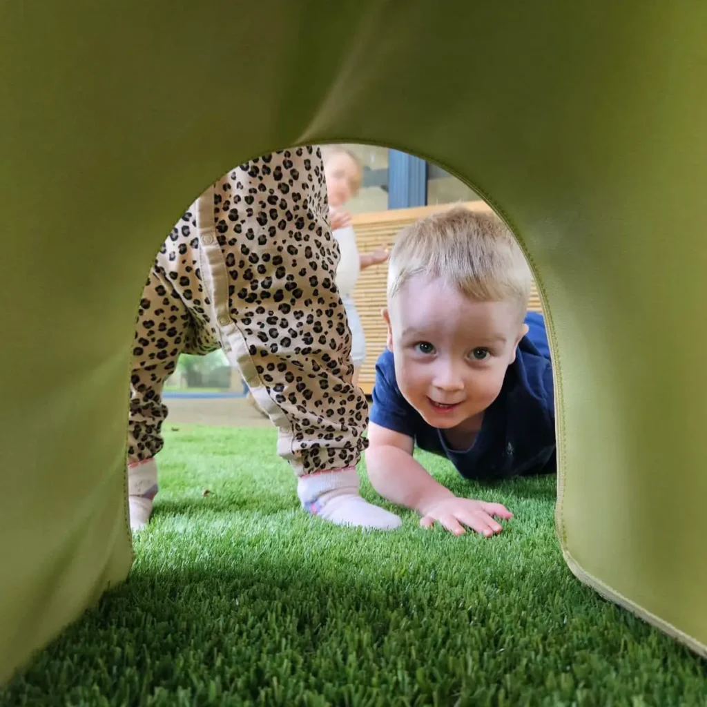 Baby looking under soft block archway