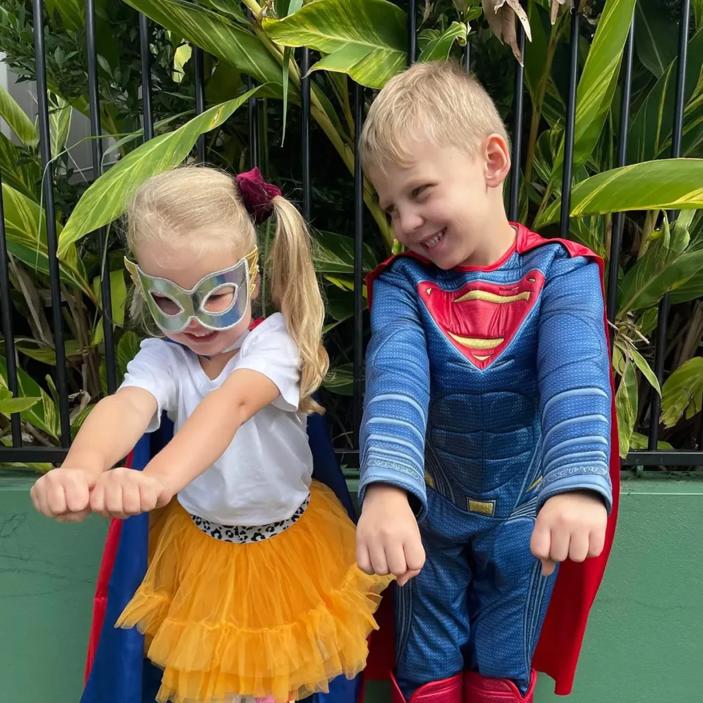 Boy and girl dressed as superheroes
