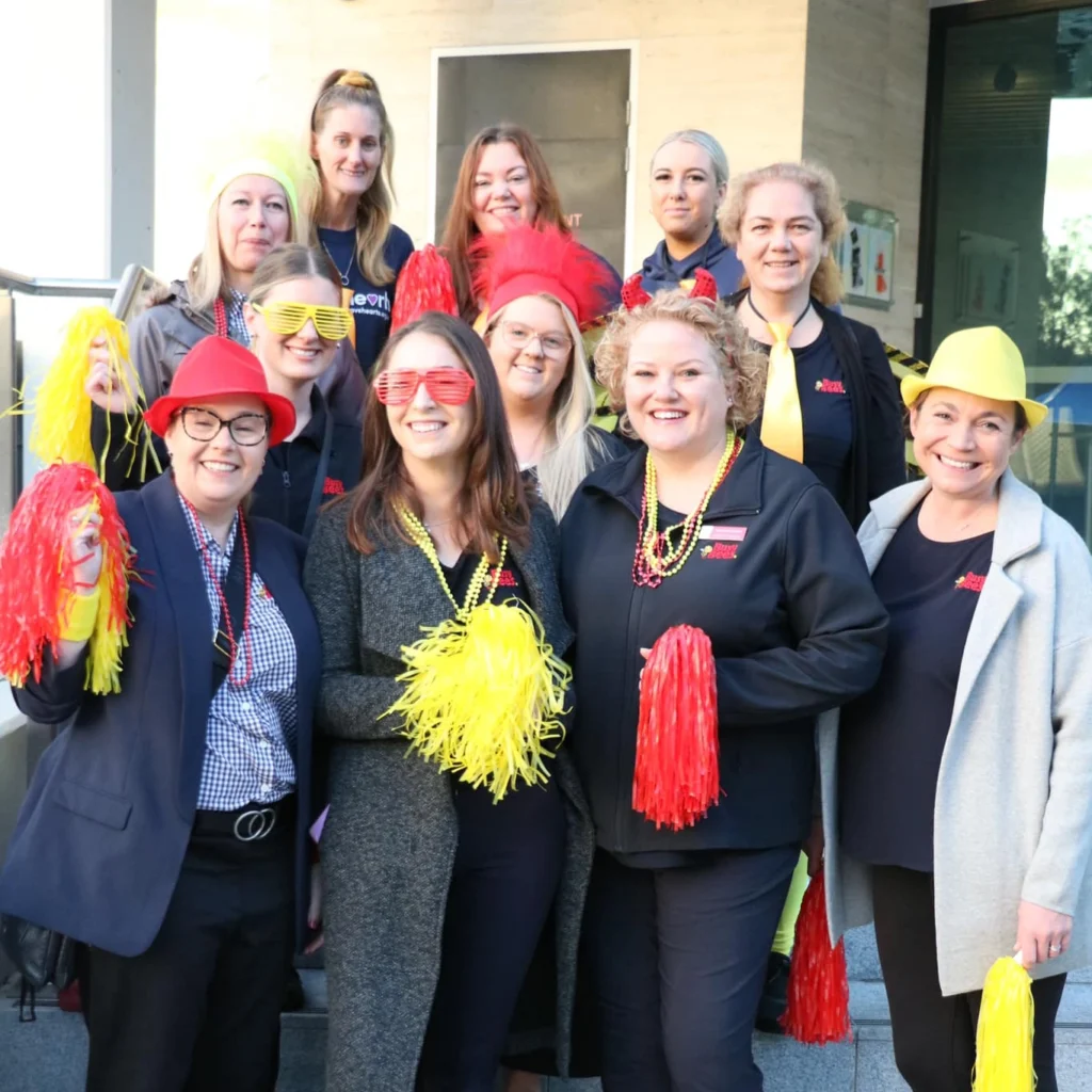 Busy Bees Educators with red and yellow pom poms