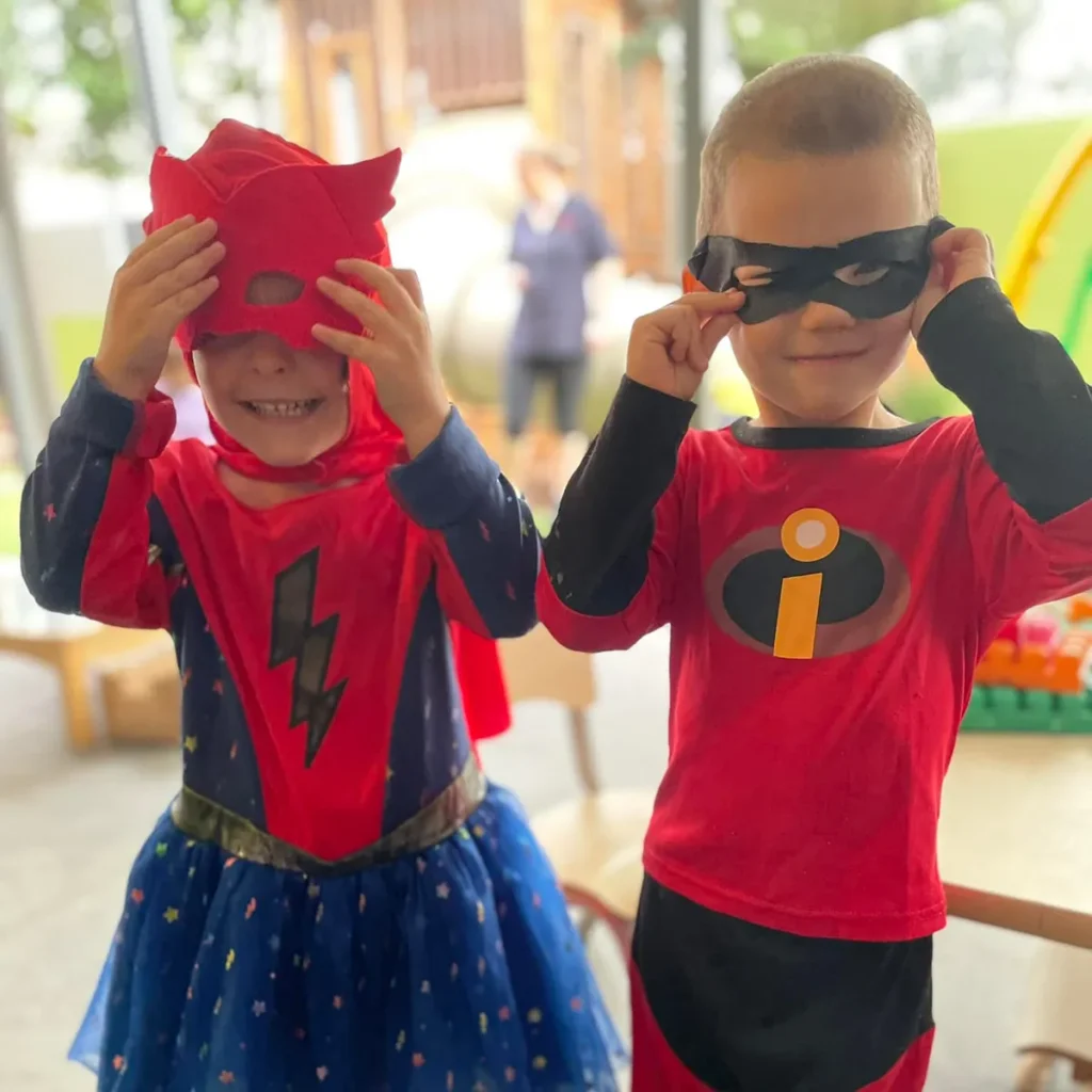 Children putting on superhero masks