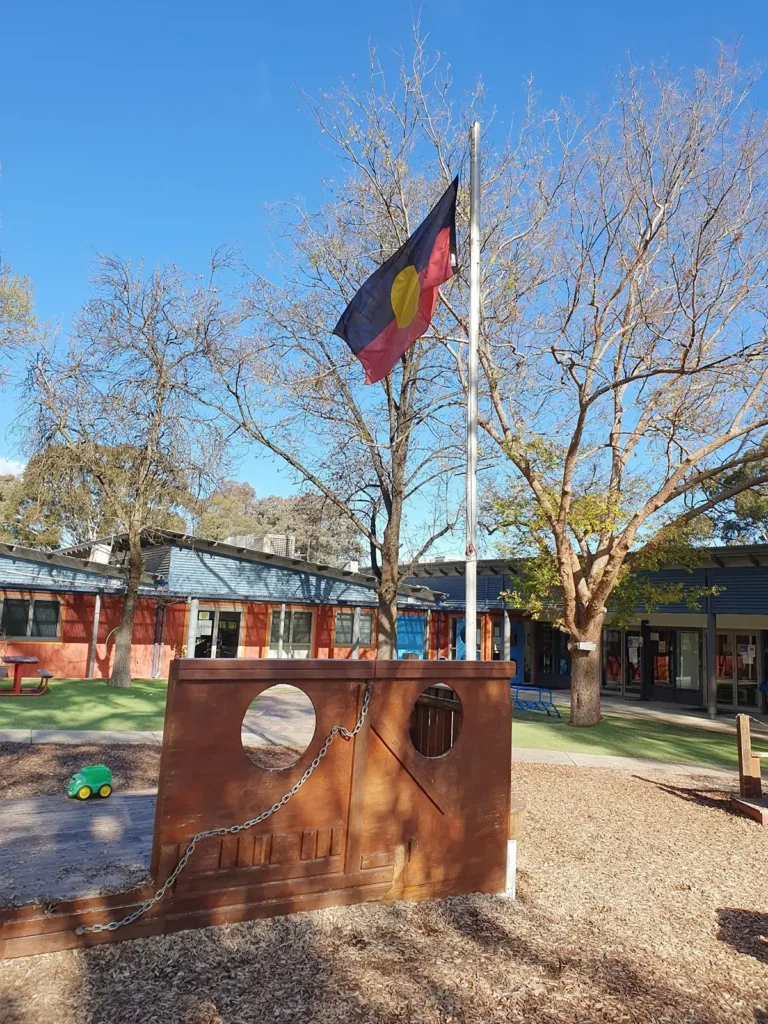 Aboriginal flag raised by Dr. Matilda House Ngambri/Wiradjuri Elder