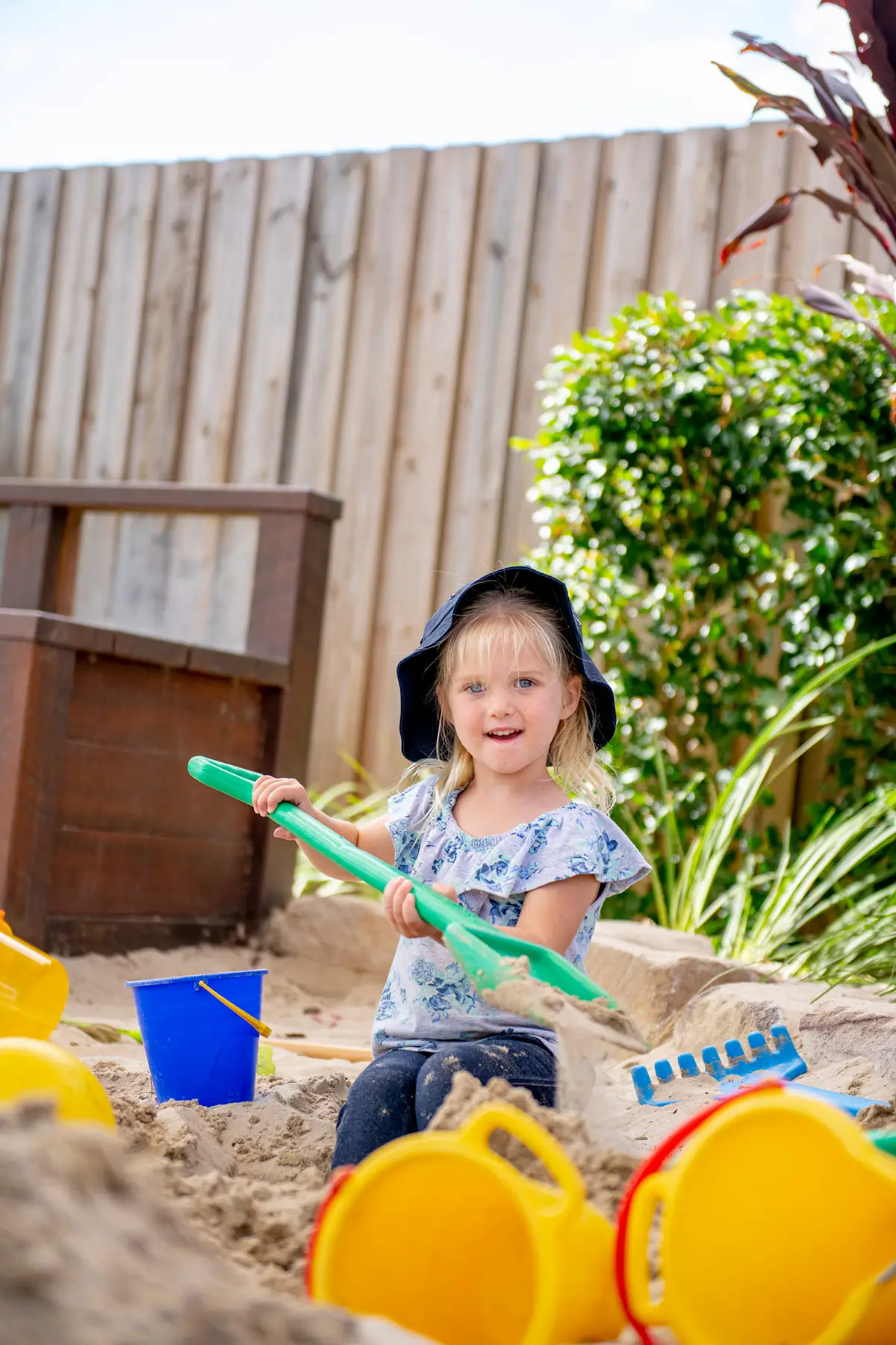 Kindergarten girl playing in sandpit at Busy Bees at Bellmere