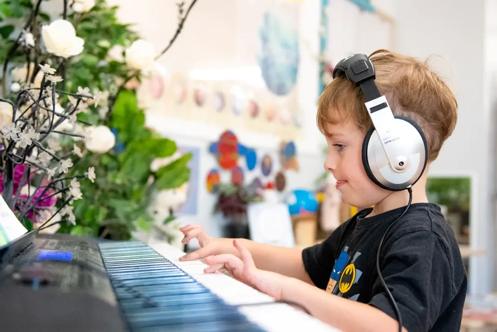 Kindy boy playing keyboard