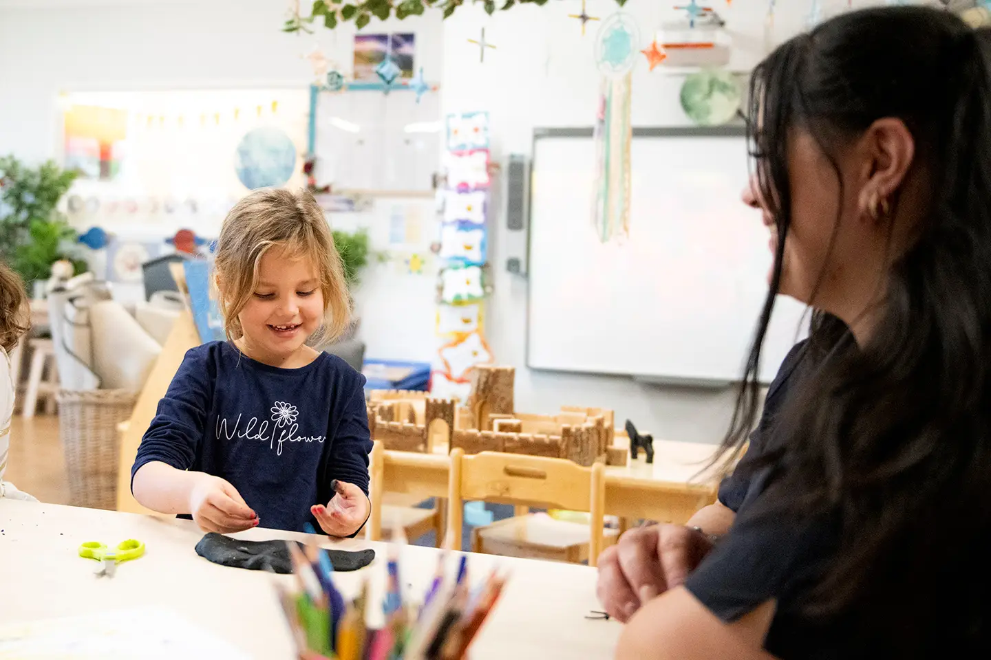 Childcare educator with kindergarten child