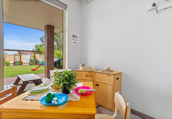 Indoor learning area connected to an outdoor play space.