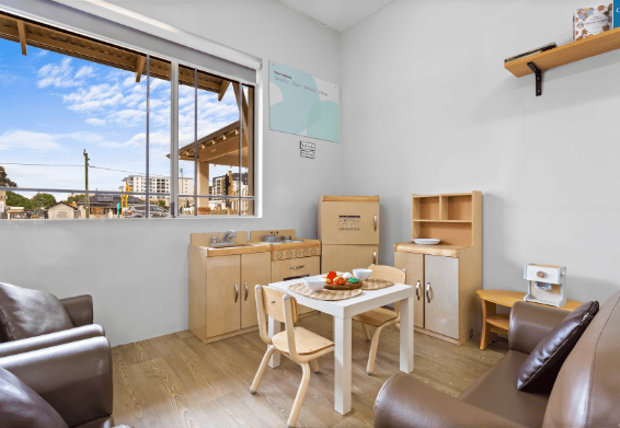 Classroom learning space with activity table and educational resources.