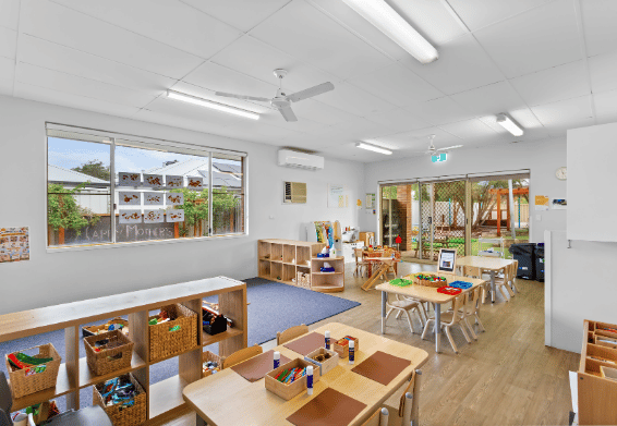 Early learning classroom with learning stations and child-sized furniture.