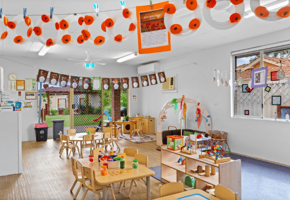 Classroom with learning stations, artwork displays and activity tables.