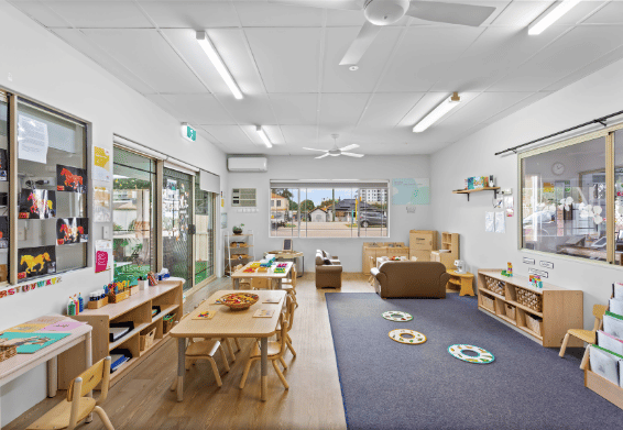 Open-plan classroom with learning stations and natural light.