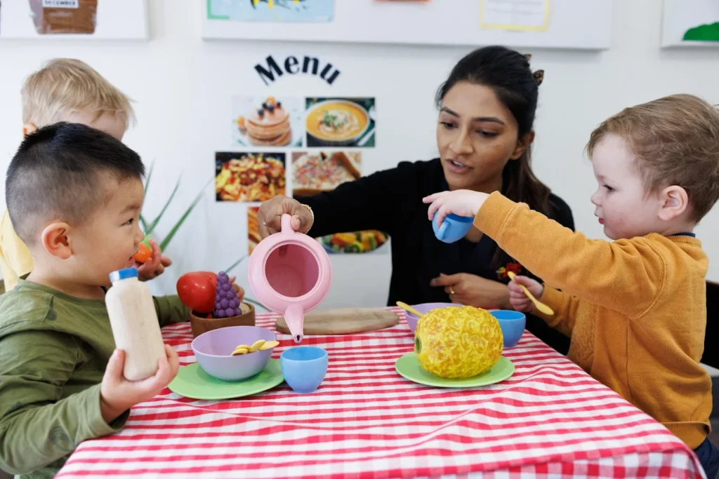 Educator from Busy Bees at Castlemaine early learning centre supervising play tea party for kids