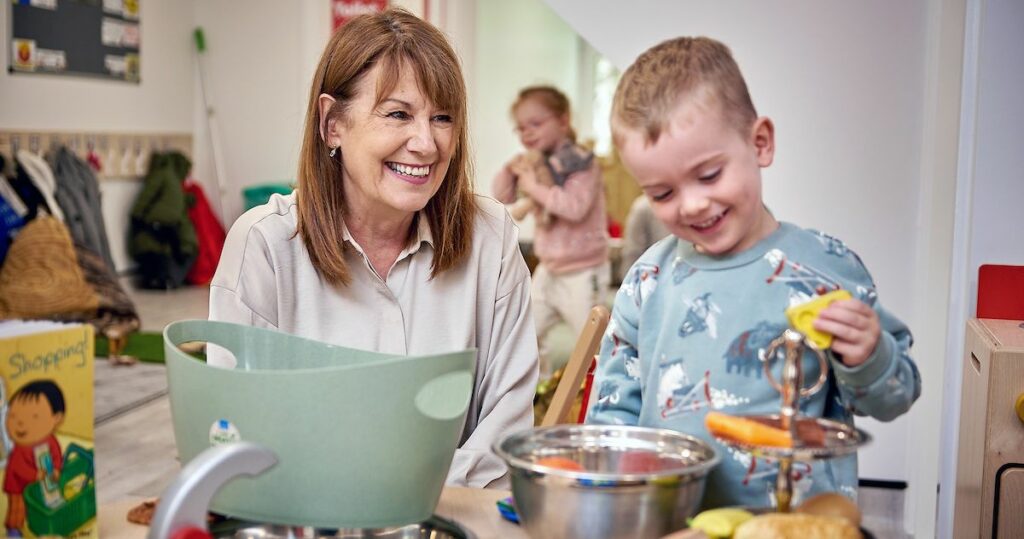 Marg Randles, Busy Bees Co-Founder with child