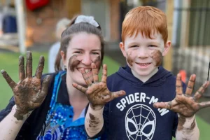 Early Childhood Educator and preschool child enjoying messy play