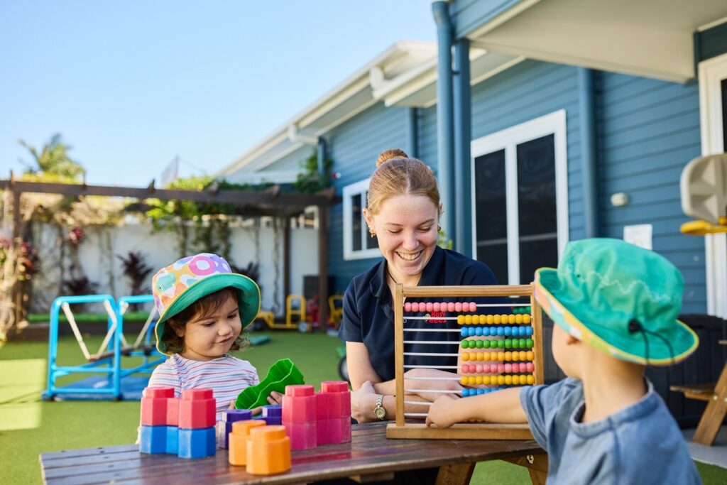 children learning and playing with a Busy Bees educator