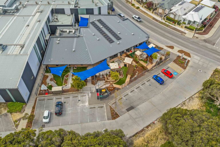 Aerial view of the Busy Bees Aveley playground, shade sails and building from above