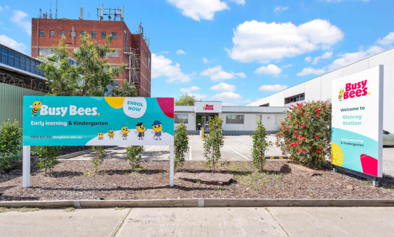 Busy Bees at Glenroy Station entrance signs beside the centre building and car park