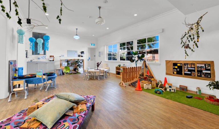 Kindergarten room at Busy Bees Moonee Valley with block play, documentation boards and sash windows